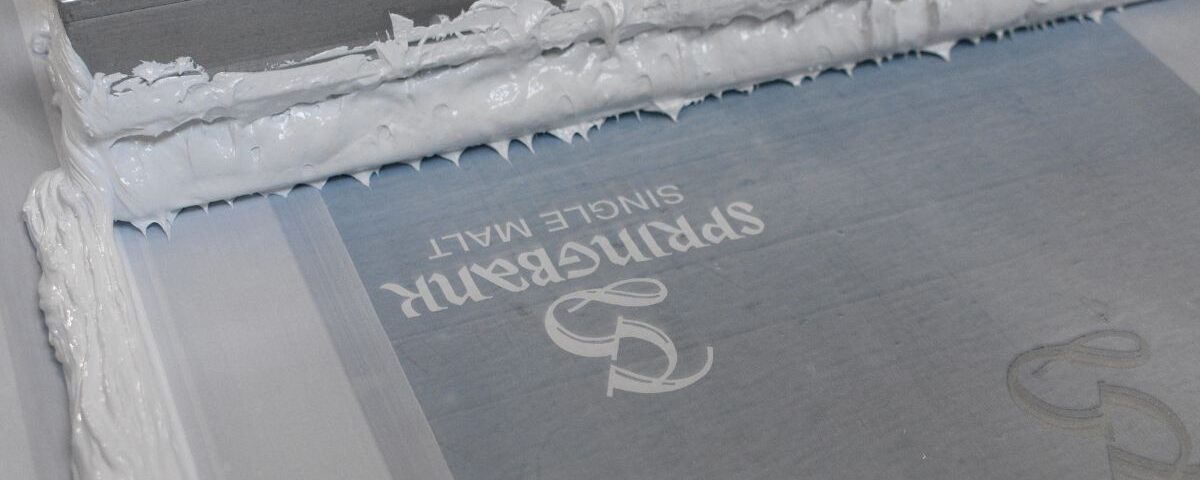 Screen Printing machine making an order of custom printed t-shirts
